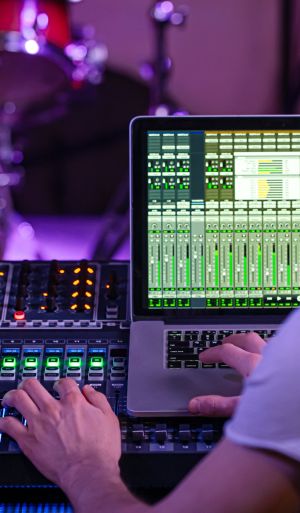 Digital mixer in a recording Studio , with a computer for recording music. On the background of the sound engineer at work. event production company in Dubai